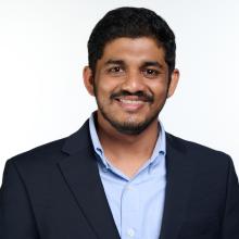Adwait Pradhan Adwait Pradhan smiles in front of a white background, wearing a black suit jacket and a light blue button-up shirt.