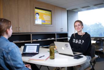 students sitting with laptops