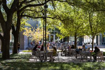 Students sitting outside building