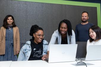 students in classroom looking at computer