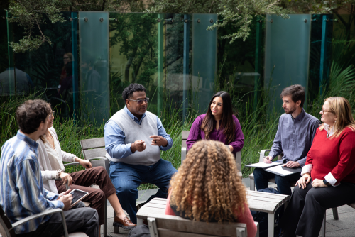 professor talking with students outside