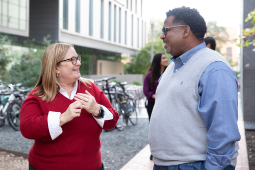 two faculty members talking